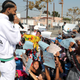 Nipsey Hussle speaks to kids at the Nipsey Hussle x PUMA Hoops Basketball Court Refurbishment Reveal Event in 2018